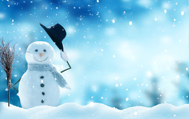 Wall Mural - new year greeting card with copy-space.happy snowman standing in christmas landscape.snow background