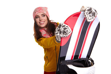 Wall Mural - Woman wearing winter suit holding a snowboard in studio