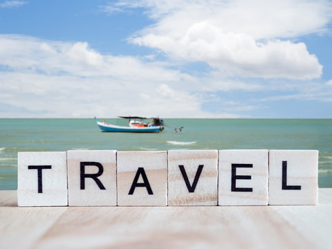 Word spell Travel on wooden background 3