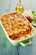 Tasty lasagne covered with cheese in baking dish