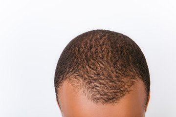 Poster - Clean, clear, purity, beauty and health concept. Close up cropped photo of afro american man's black short cutted hair and forehead, isolated on pure white background