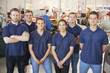 © Monkey Business - Apprentice engineers in their workplace, group portrait