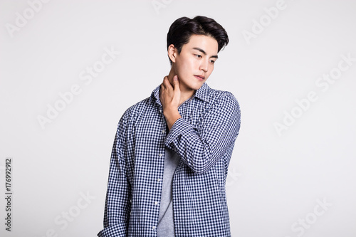 Fotografie, Obraz Studio portrait of a handsome young man posing confidently against a gray backgr