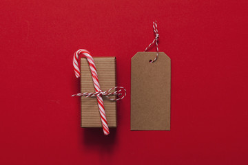 Poster - Festive Christmas present with candy cane on a red background