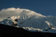 © Mick Follari/Stocksy - High altitude mountain with clouds in dramatic light