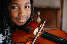 Smiling Black Girl Playing A Violin