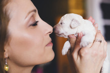Portrait Of A Young Woman And Newborn Puppy
