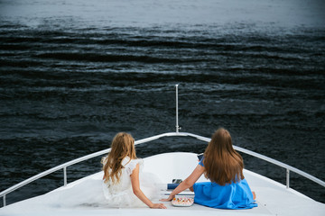 two girls are looking at the sea