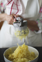 Close-up Of Woman Hand Using Potato Masher
