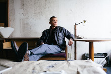 Man Sitting In Abandoned Hotel Room