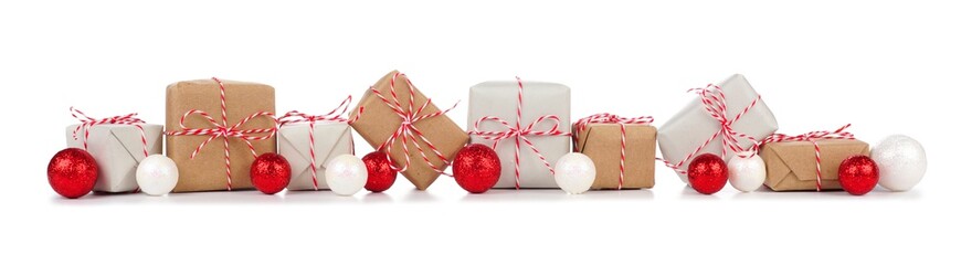 Christmas border with rustic brown and white gift boxes and red baubles isolated on a white background