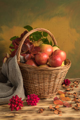 apples in a basket with autumn leaves and burlap