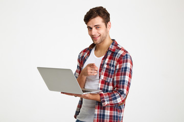 Sticker - Portrait of a confident young man holding laptop computer