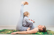 hatha yoga exercises mom with child practicing at home