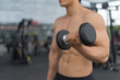 © I Believe I Can Fly - Fitness man in training showing exercises with dumbbells in gym