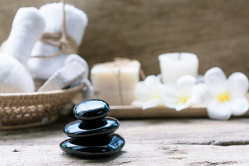 Black zen stones,beauty and skincare products  products on wooden background