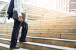 © Love You Stock - Businessman holding computer laptop walking up stairs to working. Horizontal outdoors shot.