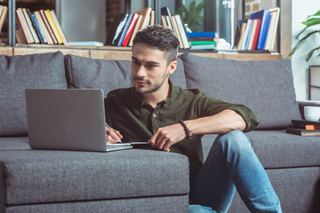 man with laptop and notebook