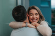 © bnenin - Beautiful lady leans to man's shoulder while he hugs her.