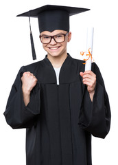 Portrait of graduate teen boy student in black graduation gown with hat and eyeglasses, holding diploma - isolated on white background. Lucky cheerful schoolboy celebrating triumph.