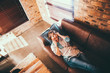 © Criene Images - Mature Woman laying on a couch hearing good news over phone call