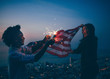© Criene Images - Afro amercian man and woman celebrating with USA flag and sparkler