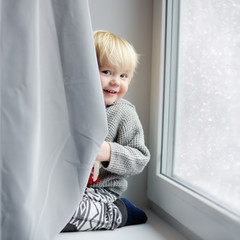 Toddler boy playing at home