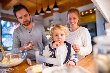 Young family making cookies at home.