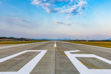 Runway, Airstrip In The Airport Terminal With Marking On Blue Sky With Clouds Background. Travel Aviation Concept.