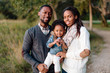 © Kristen Curette Photography LLC/Stocksy - Portrait of a beautiful African American family playing with their little girl in the park