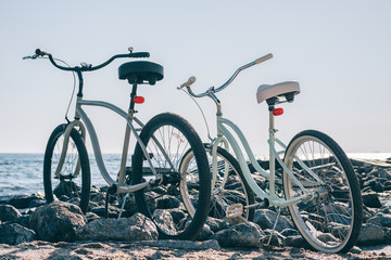 Two city bikes on the beach