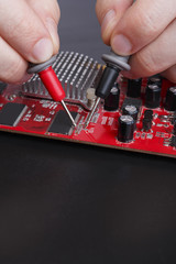 Poster - Electronic circuit red board inspecting close up