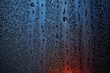 © Borislav Zhuykov/Stocksy - Raindrops on sweaty window with red tint