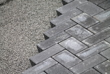 Gray Cement Bricks  And Little Stones Building A Floor.