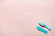 Two Turquoise hair comb crest brushes with handle for all types, isolated on pink copy space background. Minimalistic feminine flat lay.