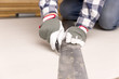 © artursfoto - worker cutting plasterboard with construction knife. Attic renovation