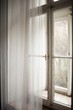 © Marija Mandic/Stocksy - Window with a white curtain during the day light