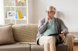 © Syda Productions - senior man with tablet pc sitting on sofa at home