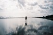 © Jacob Lund/Stocksy - Woman walking on beautiful beach