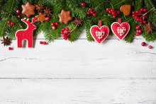Christmas Background With Green Fir Branches, Heart And Red Berries