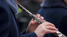Man In Uniform Skillfully Playing Oboe Accompanied By Brass Band, Performance