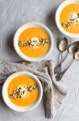 Wall Mural - Squash soup on gray concrete background