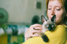 Close Up Portrait Of Young Woman Holding Cute Kitten