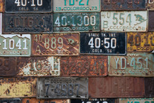 Vintage Colorado License Plates Mounted On An Exterior Wall