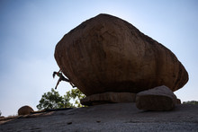 Woman Climbing On A Huge Boulder