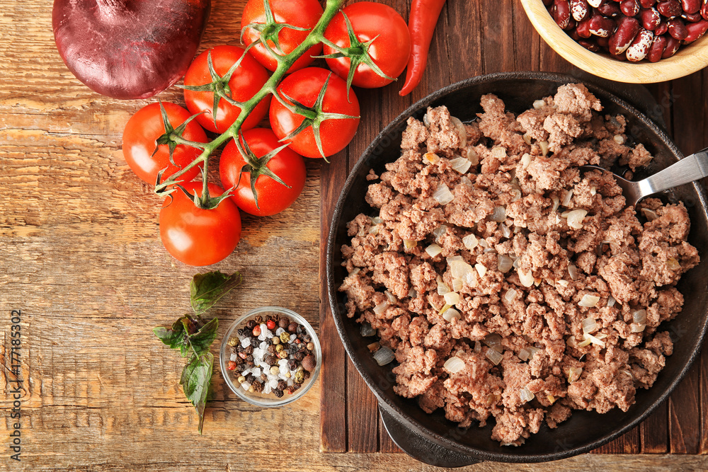 Cooked minced meat and vegetables on kitchen table