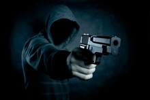 Hooded Man With A Gun In The Dark 