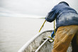 © Kristine Weilert/Stocksy - Fisherman throwing an anchor over a fishing boat