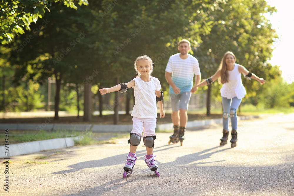 Family rollerskating in park