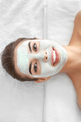 Poster - Young woman with facial mask in spa salon